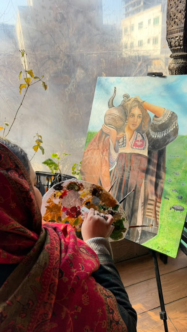 Zuhra working on a painting inspired by Afghan culture